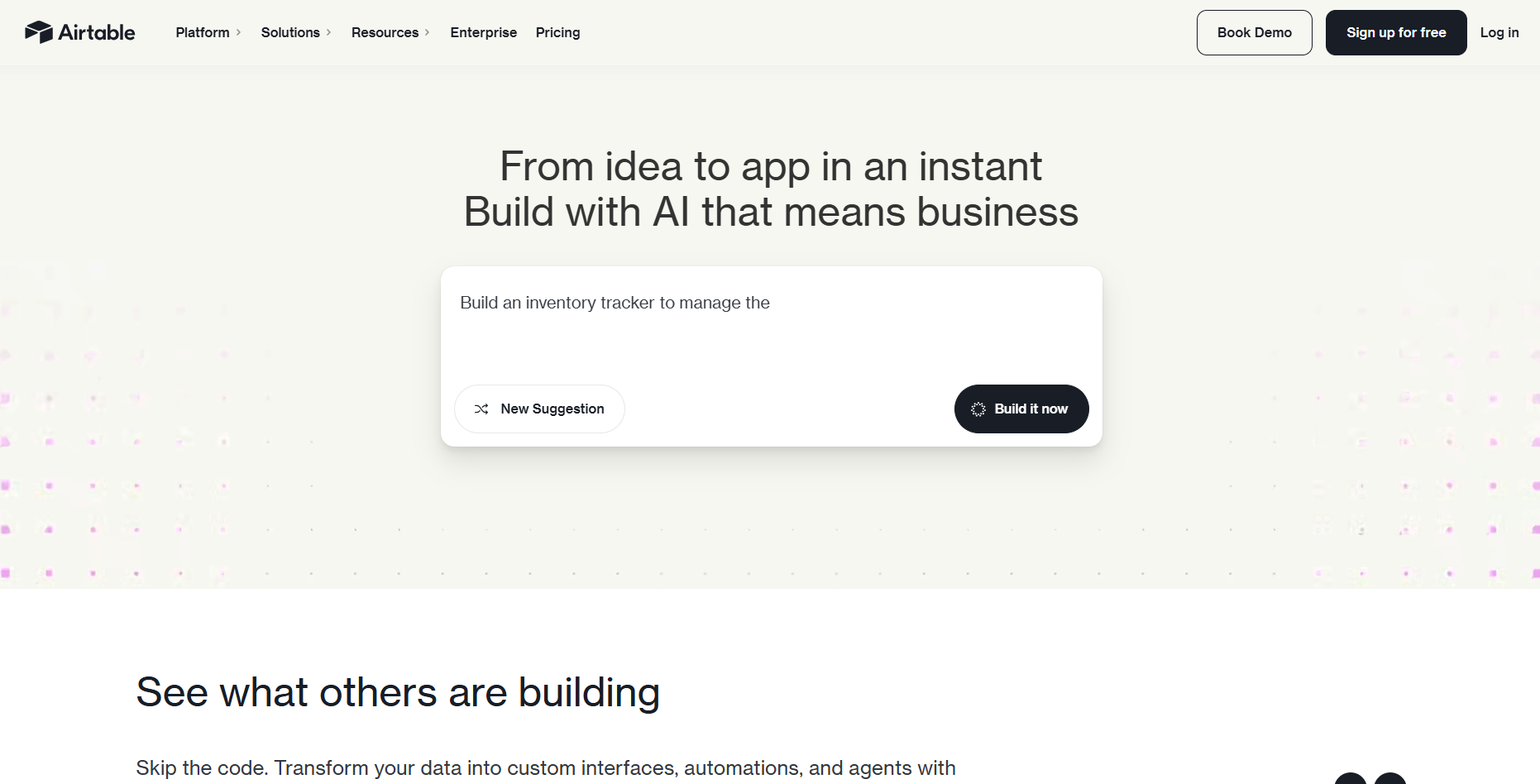 Website homepage with the headline 'From idea to app in an instant. Build with AI that means business.' Features a build suggestion box and call-to-action buttons. The tone is inviting and modern.